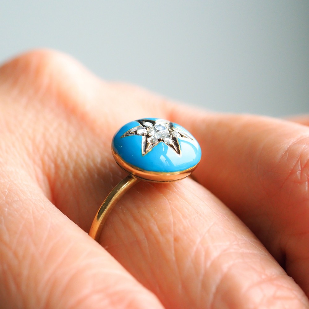 A 9ct yellow gold ring featuring a bright blue enamel dome set with a central six-pointed diamond star motif. View VI