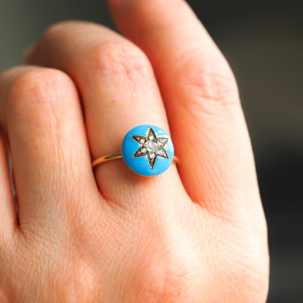 A 9ct yellow gold ring featuring a bright blue enamel dome set with a central six-pointed diamond star motif. View VII