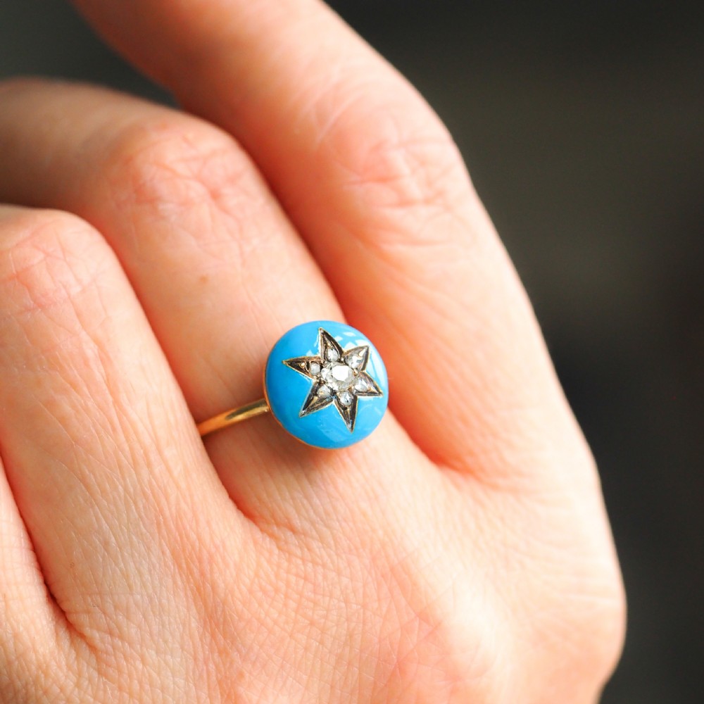 A 9ct yellow gold ring featuring a bright blue enamel dome set with a central six-pointed diamond star motif. View VIII