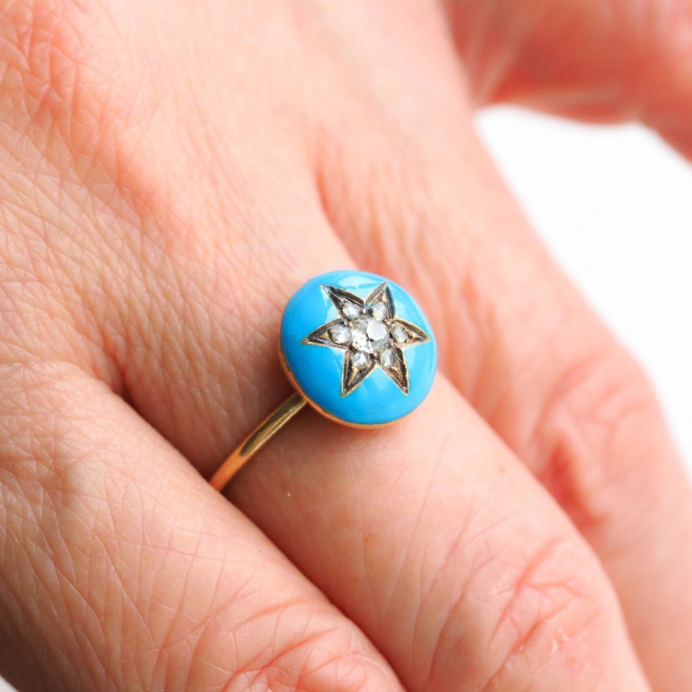 A 9ct yellow gold ring featuring a bright blue enamel dome set with a central six-pointed diamond star motif. View IX
