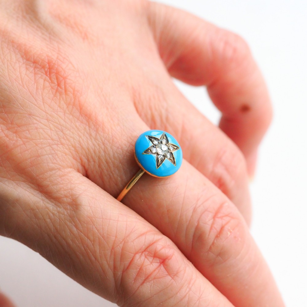 A 9ct yellow gold ring featuring a bright blue enamel dome set with a central six-pointed diamond star motif. View X