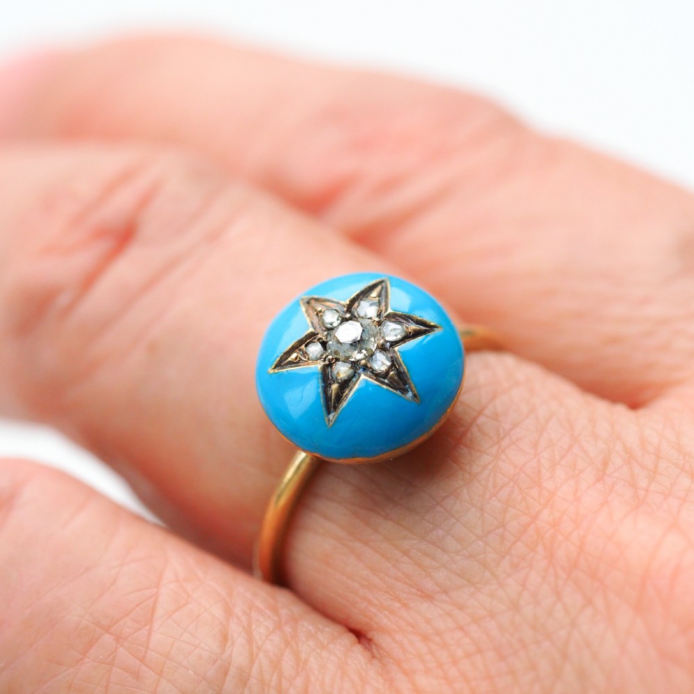 A 9ct yellow gold ring featuring a bright blue enamel dome set with a central six-pointed diamond star motif. View XI