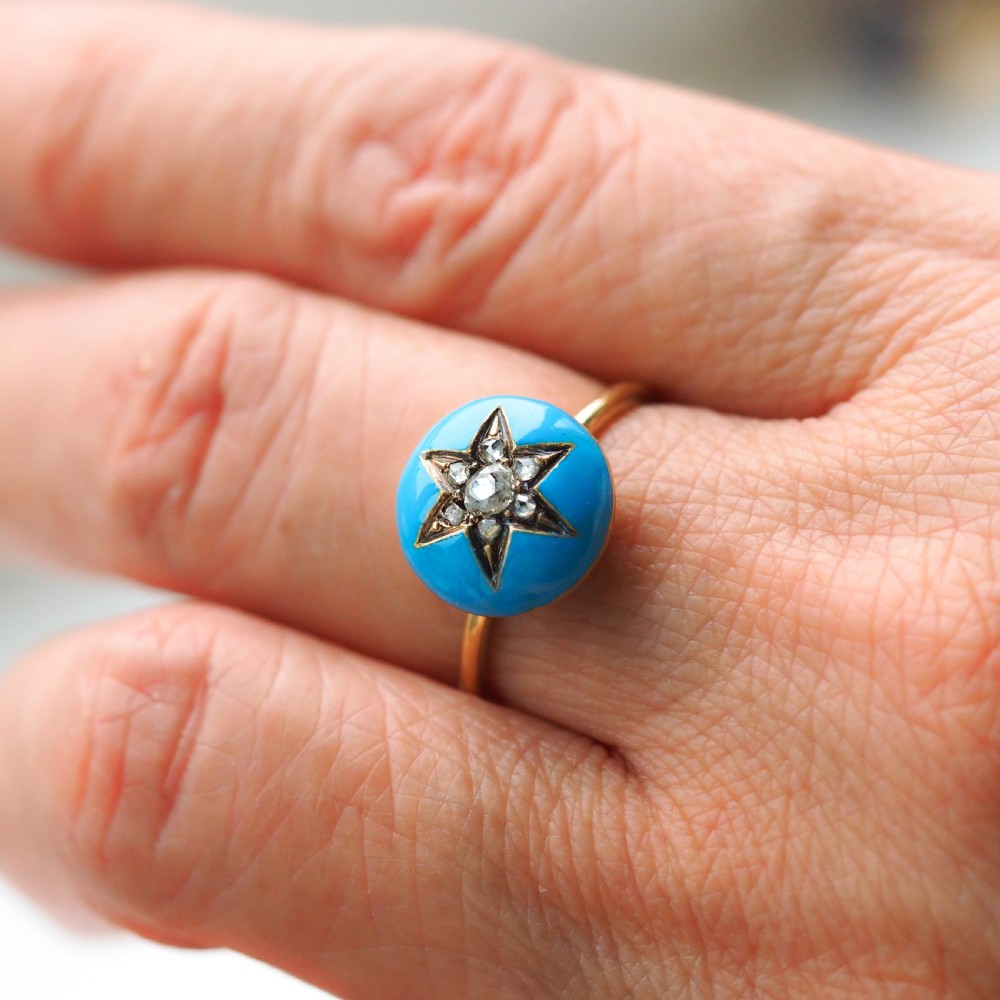 A 9ct yellow gold ring featuring a bright blue enamel dome set with a central six-pointed diamond star motif. View XII