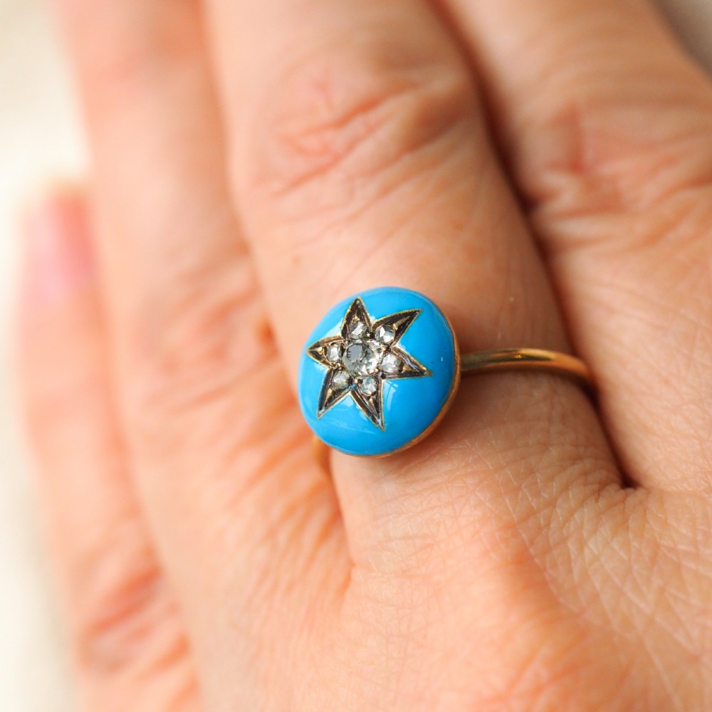 A 9ct yellow gold ring featuring a bright blue enamel dome set with a central six-pointed diamond star motif. View XIII