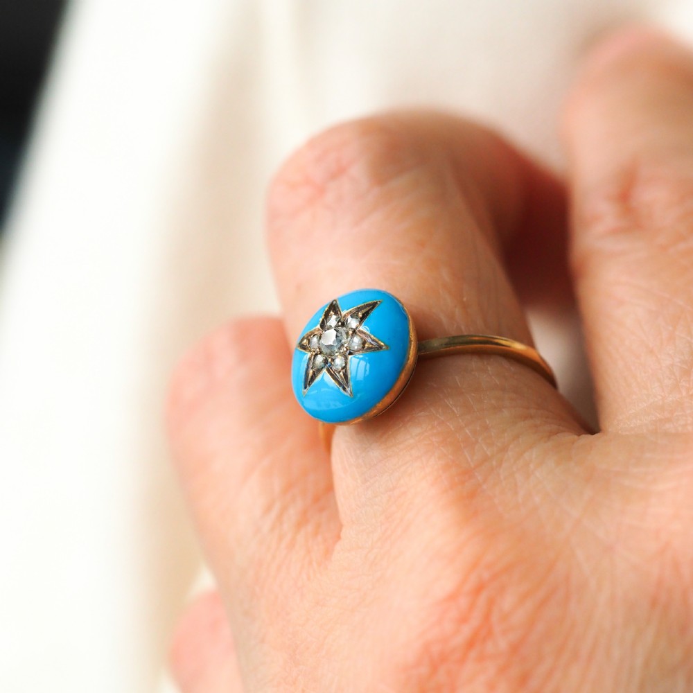 A 9ct yellow gold ring featuring a bright blue enamel dome set with a central six-pointed diamond star motif. View XIV