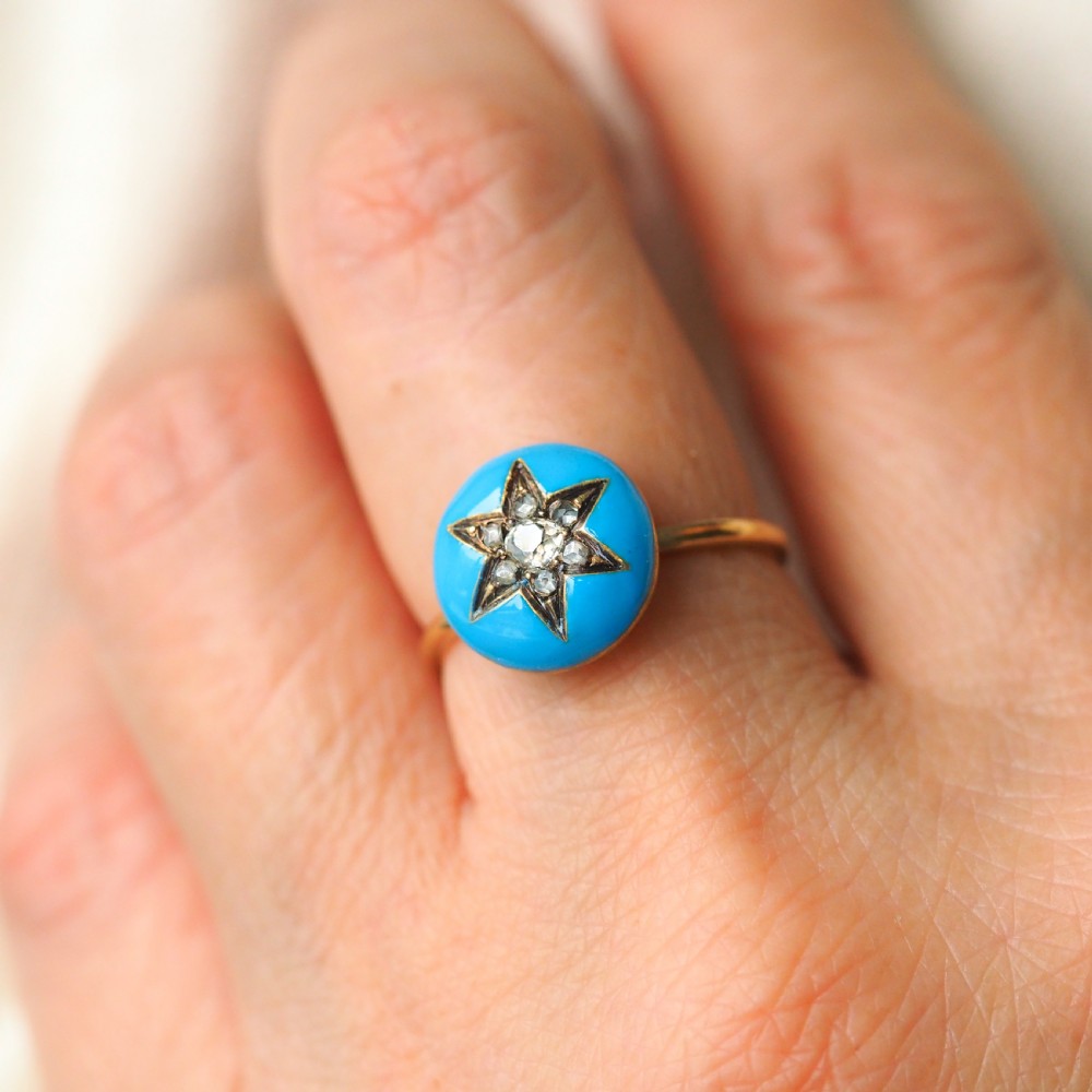 A 9ct yellow gold ring featuring a bright blue enamel dome set with a central six-pointed diamond star motif. View XV