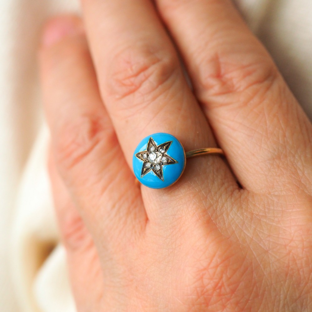 A 9ct yellow gold ring featuring a bright blue enamel dome set with a central six-pointed diamond star motif. View XVI