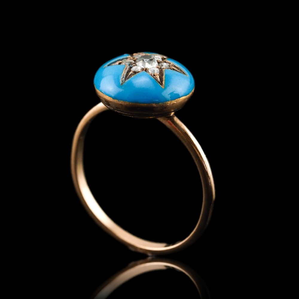 A 9ct yellow gold ring featuring a bright blue enamel dome set with a central six-pointed diamond star motif. View XVII
