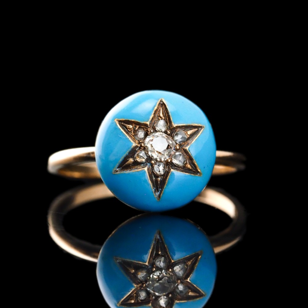 A 9ct yellow gold ring featuring a bright blue enamel dome set with a central six-pointed diamond star motif. View XVIII