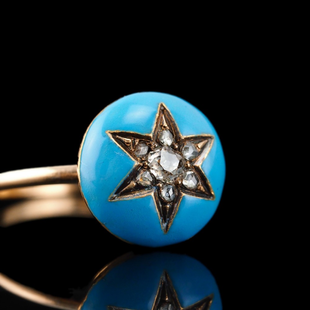 A 9ct yellow gold ring featuring a bright blue enamel dome set with a central six-pointed diamond star motif. View XIX