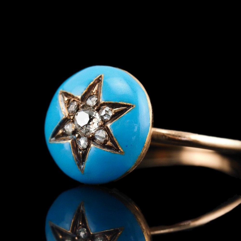 A 9ct yellow gold ring featuring a bright blue enamel dome set with a central six-pointed diamond star motif. View XXI