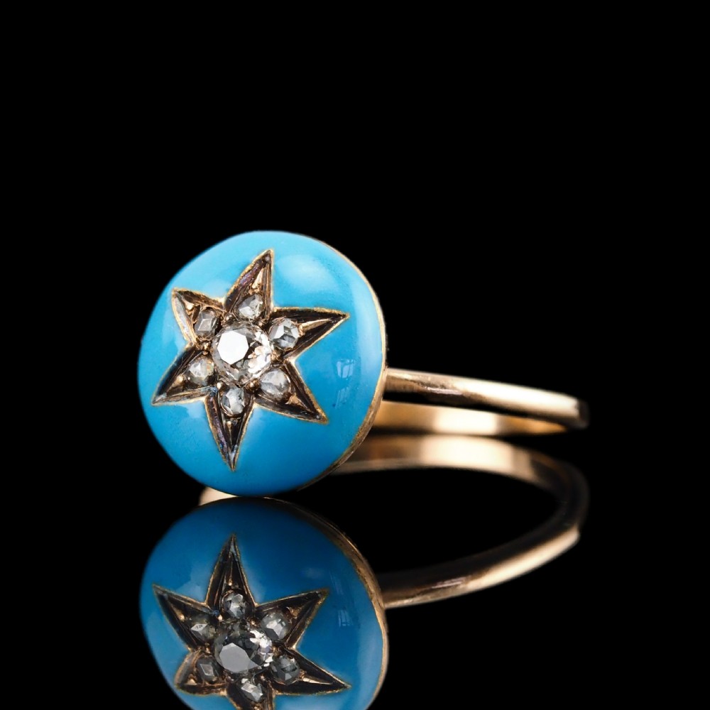 A 9ct yellow gold ring featuring a bright blue enamel dome set with a central six-pointed diamond star motif. View XXII
