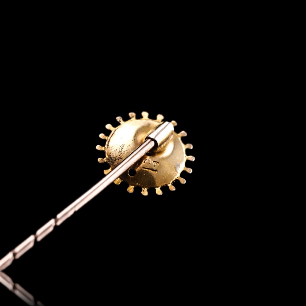 A Victorian 14ct gold stick pin featuring a round head with a star-set diamond and a beaded granulated outer border. View III