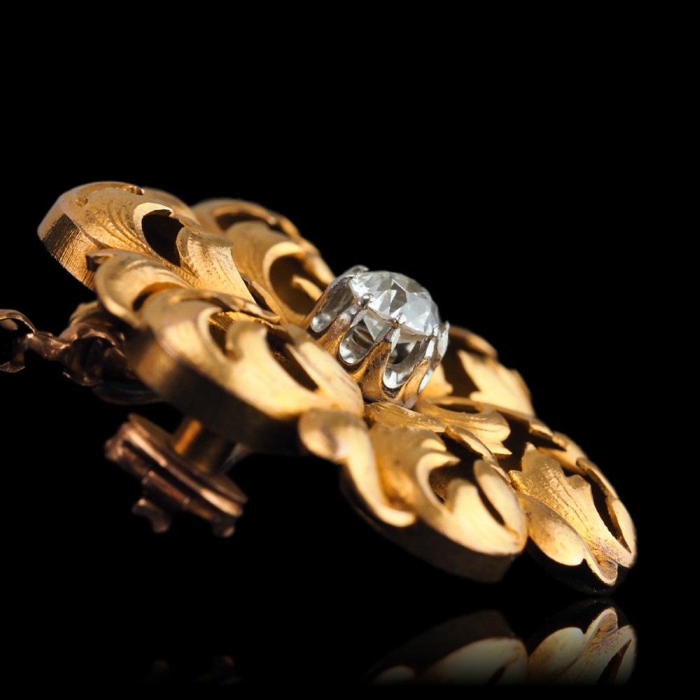 An 18ct yellow gold Victorian pendant brooch with openwork acanthus leaf scrollwork and a central round diamond. View XII