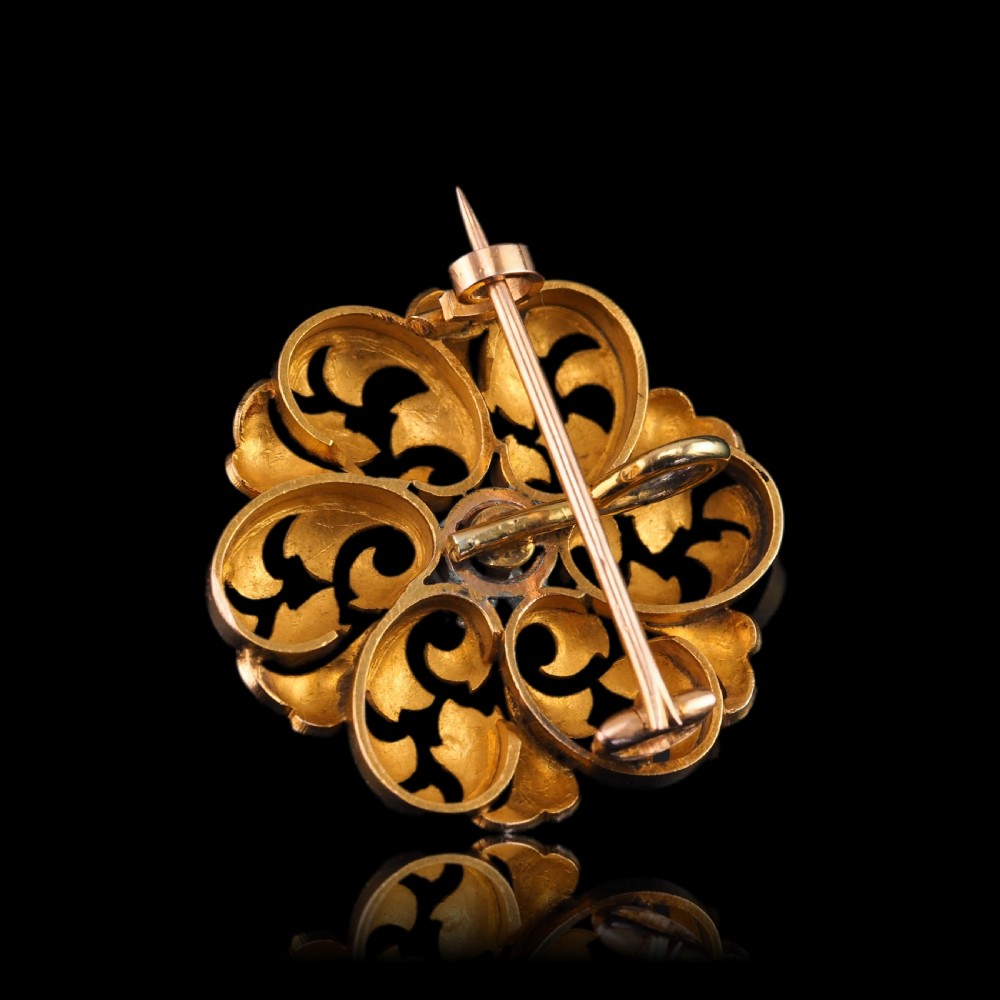 An 18ct yellow gold Victorian pendant brooch with openwork acanthus leaf scrollwork and a central round diamond. View XX