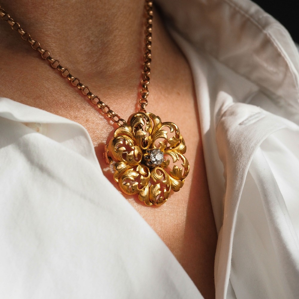 An 18ct yellow gold Victorian pendant brooch with openwork acanthus leaf scrollwork and a central round diamond. View XXIV