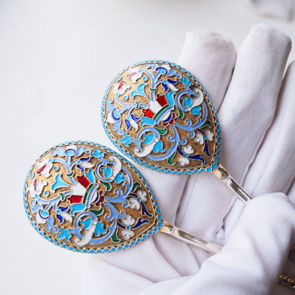 A pair of late nineteenth century Russian solid silver spoons featuring floral cloisonne enamel in turquoise, blue, red, and white on gilded teardrop bowls with twisted handles. View III