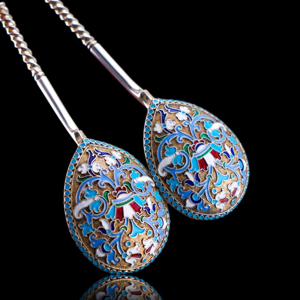 A pair of late nineteenth century Russian solid silver spoons featuring floral cloisonne enamel in turquoise, blue, red, and white on gilded teardrop bowls with twisted handles. View VIII