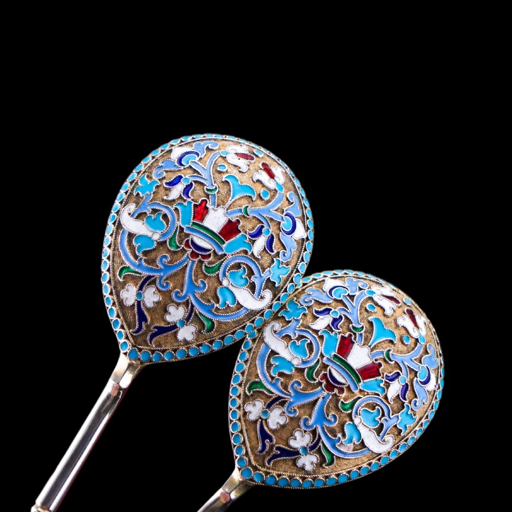 A pair of late nineteenth century Russian solid silver spoons featuring floral cloisonne enamel in turquoise, blue, red, and white on gilded teardrop bowls with twisted handles. View IX