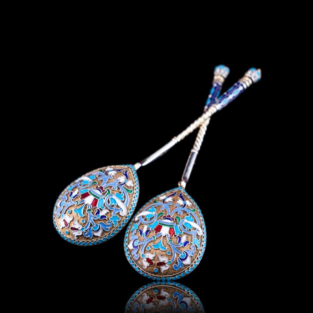 A pair of late nineteenth century Russian solid silver spoons featuring floral cloisonne enamel in turquoise, blue, red, and white on gilded teardrop bowls with twisted handles. View XIII