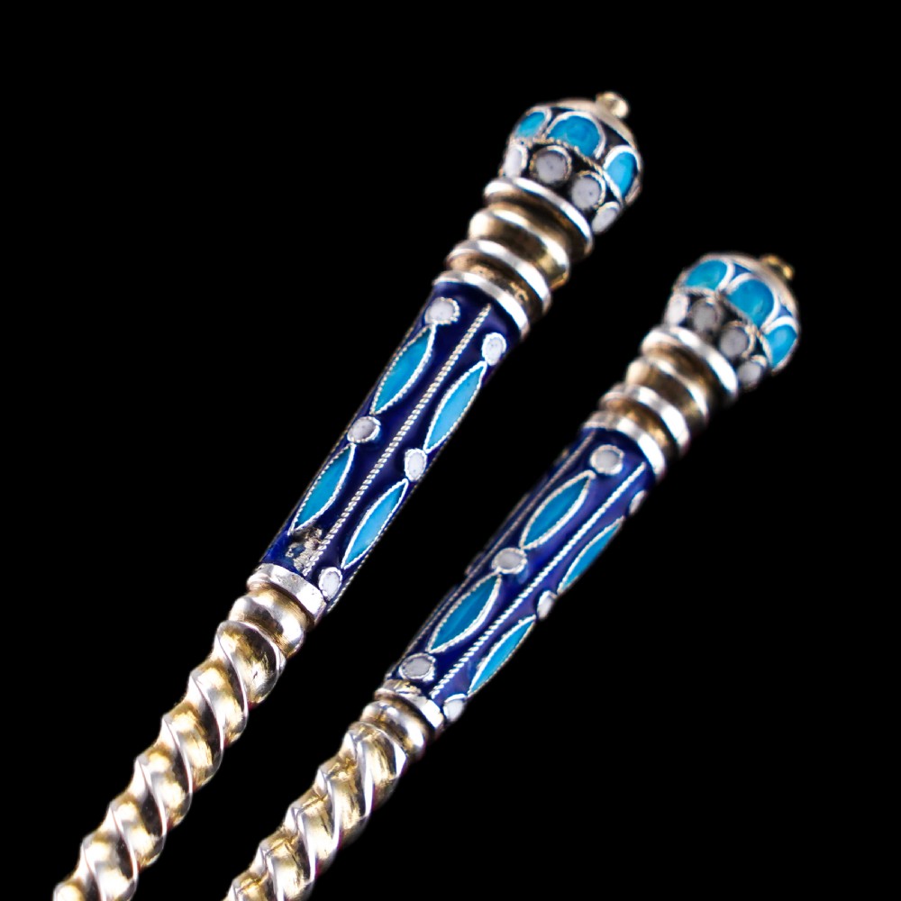 A pair of late nineteenth century Russian solid silver spoons featuring floral cloisonne enamel in turquoise, blue, red, and white on gilded teardrop bowls with twisted handles. View XIV
