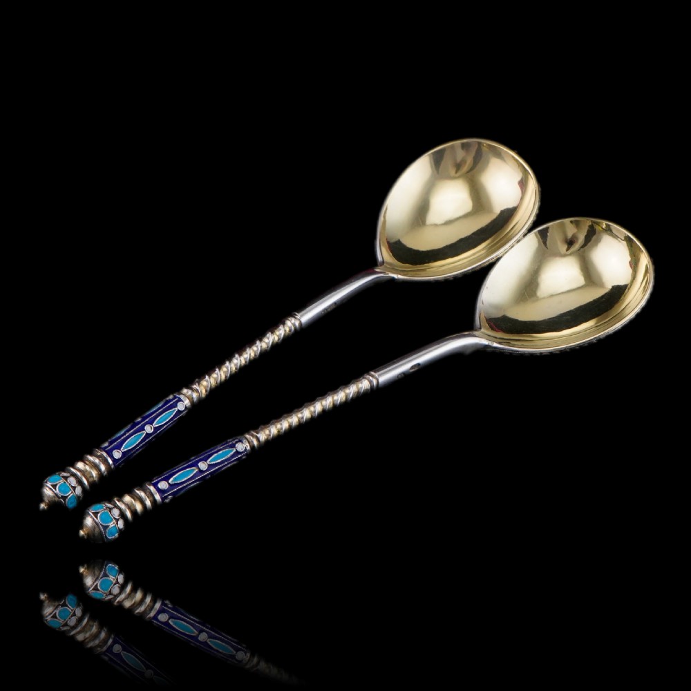 A pair of late nineteenth century Russian solid silver spoons featuring floral cloisonne enamel in turquoise, blue, red, and white on gilded teardrop bowls with twisted handles. View XVIII