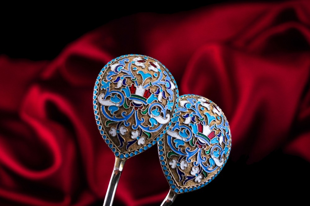 A pair of late nineteenth century Russian solid silver spoons featuring floral cloisonne enamel in turquoise, blue, red, and white on gilded teardrop bowls with twisted handles. View XXI