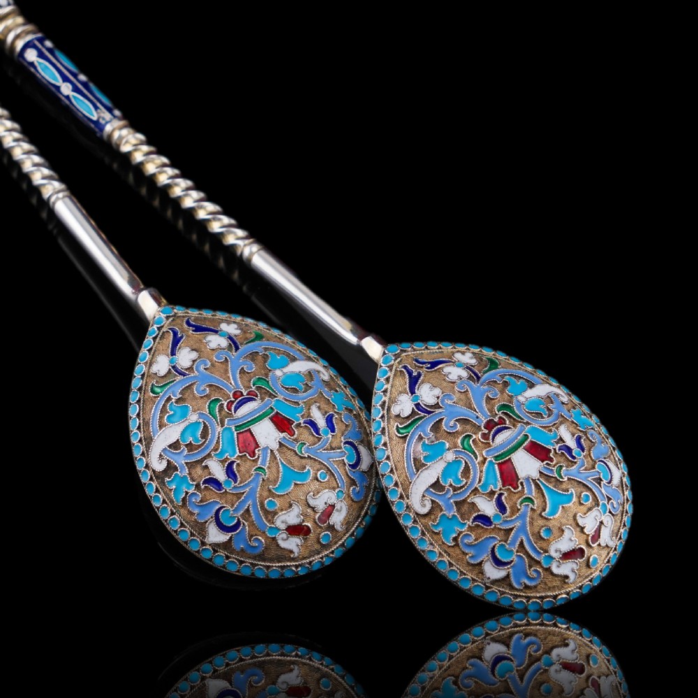 A pair of late nineteenth century Russian solid silver spoons featuring floral cloisonne enamel in turquoise, blue, red, and white on gilded teardrop bowls with twisted handles. View XXIV