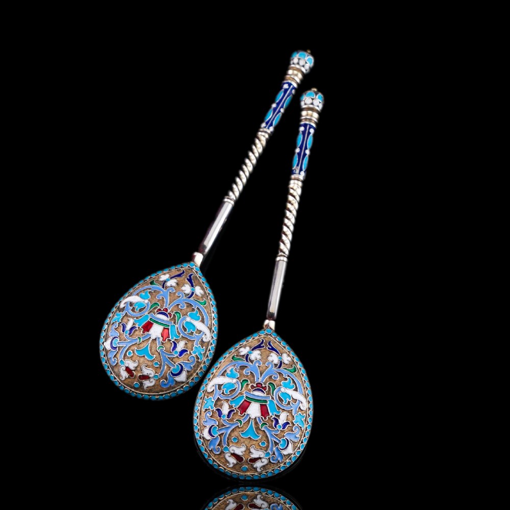 A pair of late nineteenth century Russian solid silver spoons featuring floral cloisonne enamel in turquoise, blue, red, and white on gilded teardrop bowls with twisted handles. View XXV