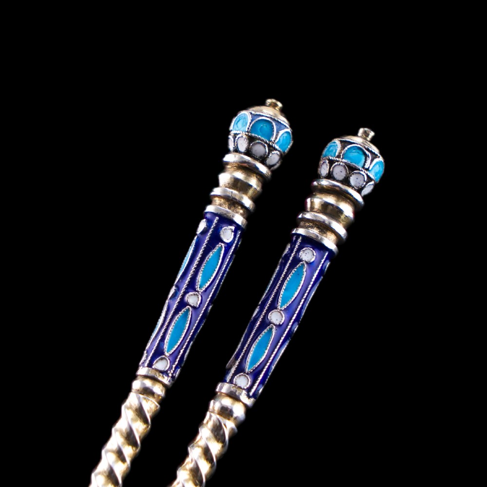 A pair of late 19th-century Russian solid silver spoons featuring turquoise, blue, and white cloisonne enamel foliate decoration on silver-gilt teardrop bowls with twisted handles. View XII