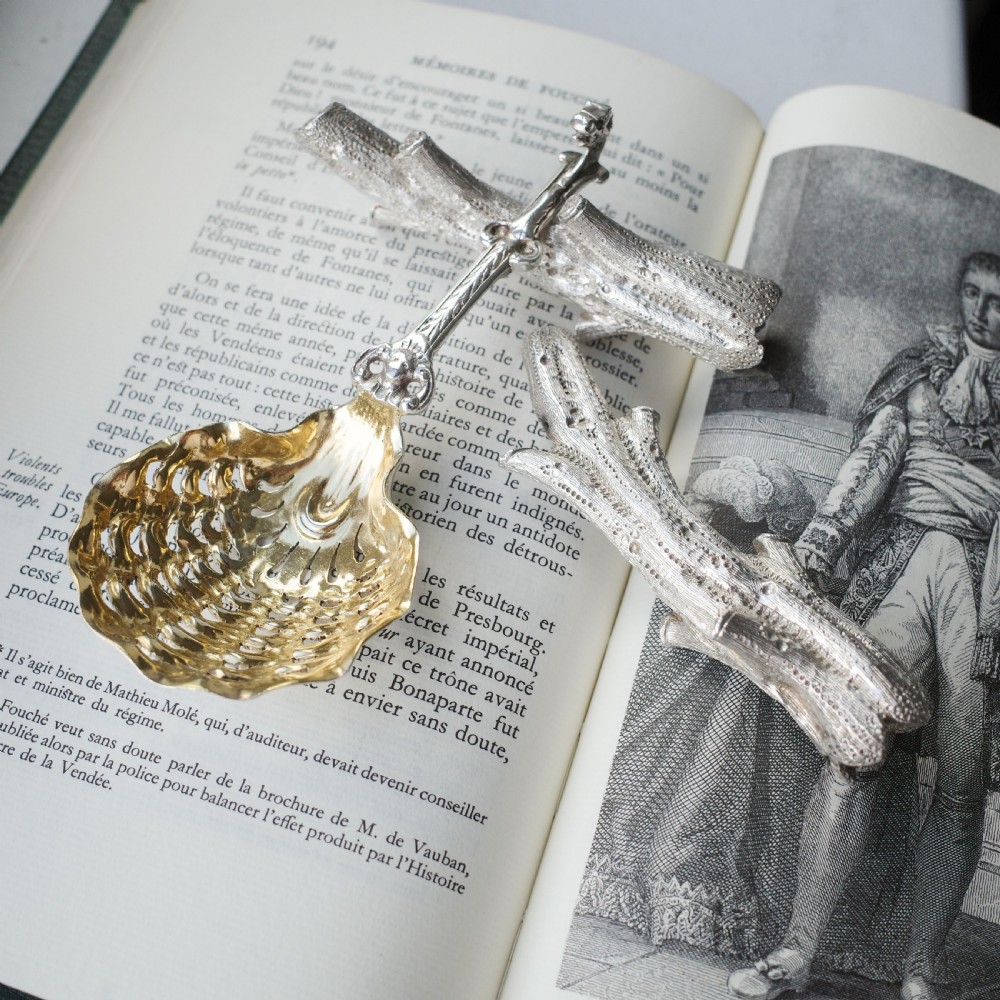 A detailed close-up of a Victorian solid silver knife rest fashioned in the shape of a textured tree branch. View IX
