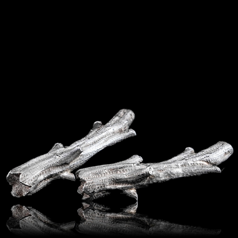 A detailed close-up of a Victorian solid silver knife rest fashioned in the shape of a textured tree branch. View XXIV
