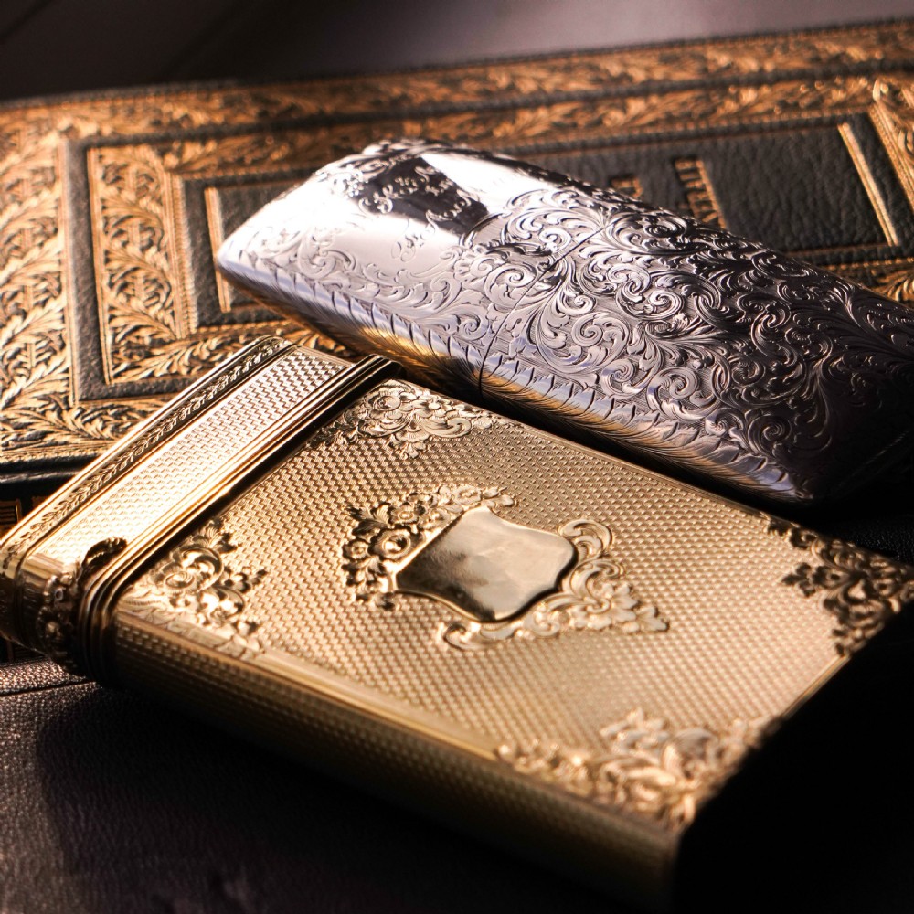 An antique Victorian sterling silver gilt cigar case featuring fine engine-turned texturing, scroll engraving, and a central unengraved cartouche. View XII