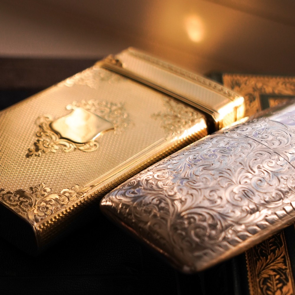 An antique Victorian sterling silver gilt cigar case featuring fine engine-turned texturing, scroll engraving, and a central unengraved cartouche. View XIII