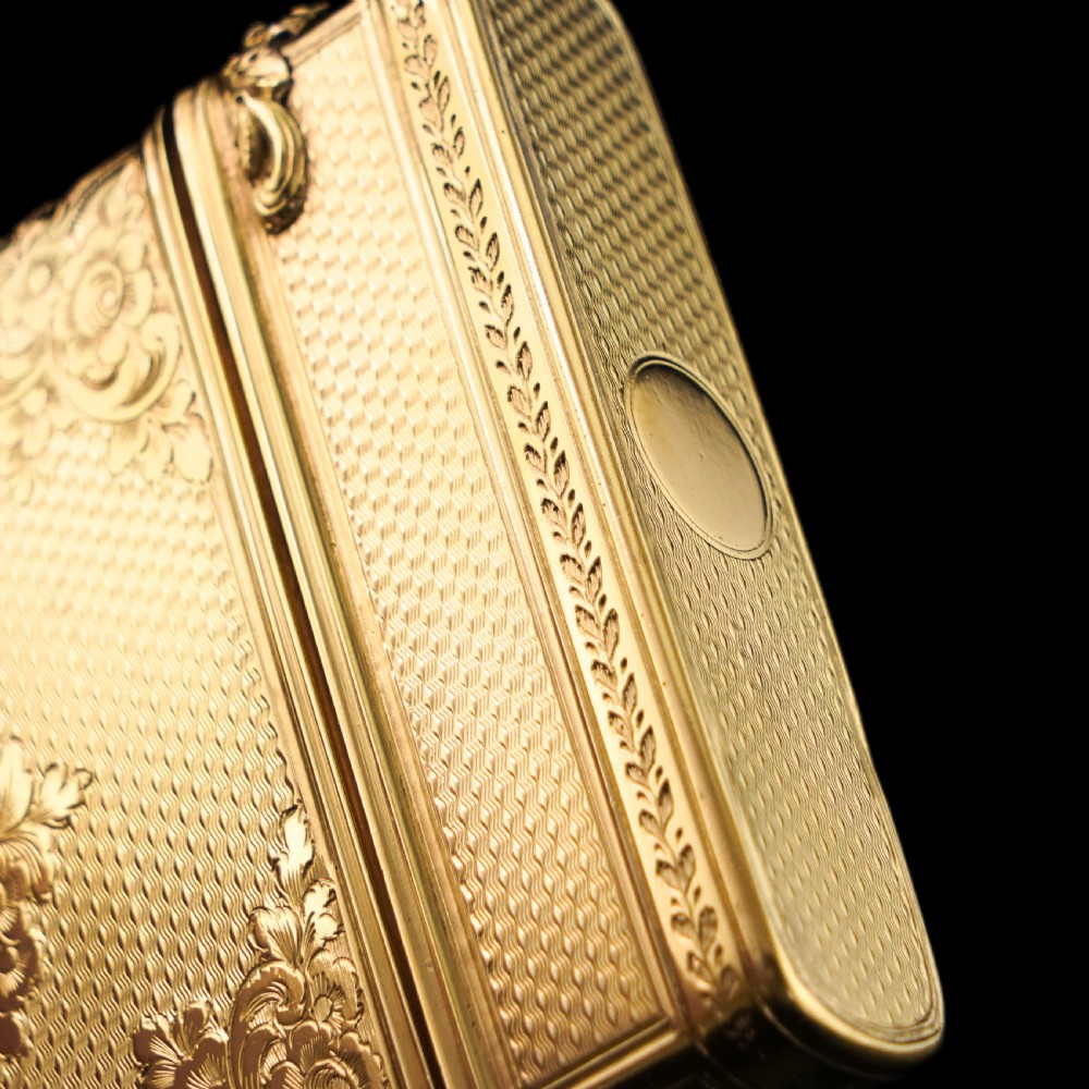 An antique Victorian sterling silver gilt cigar case featuring fine engine-turned texturing, scroll engraving, and a central unengraved cartouche. View XV