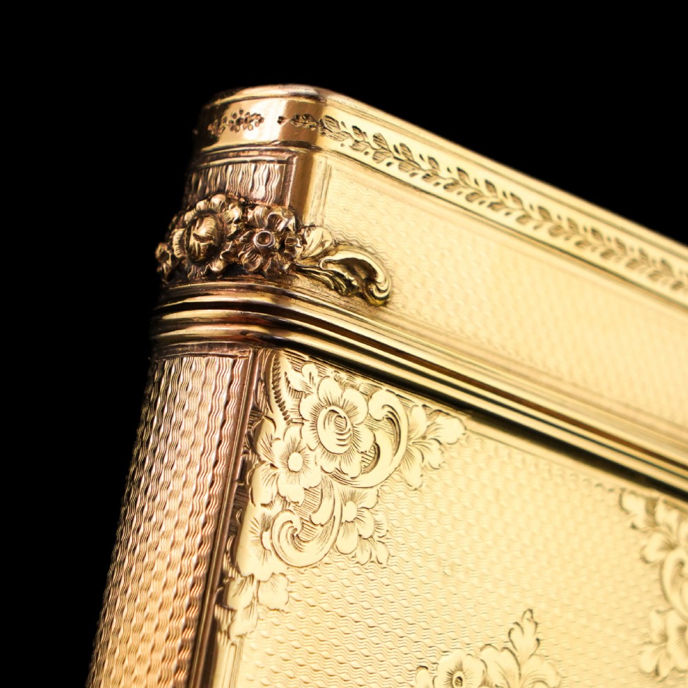 An antique Victorian sterling silver gilt cigar case featuring fine engine-turned texturing, scroll engraving, and a central unengraved cartouche. View XVI