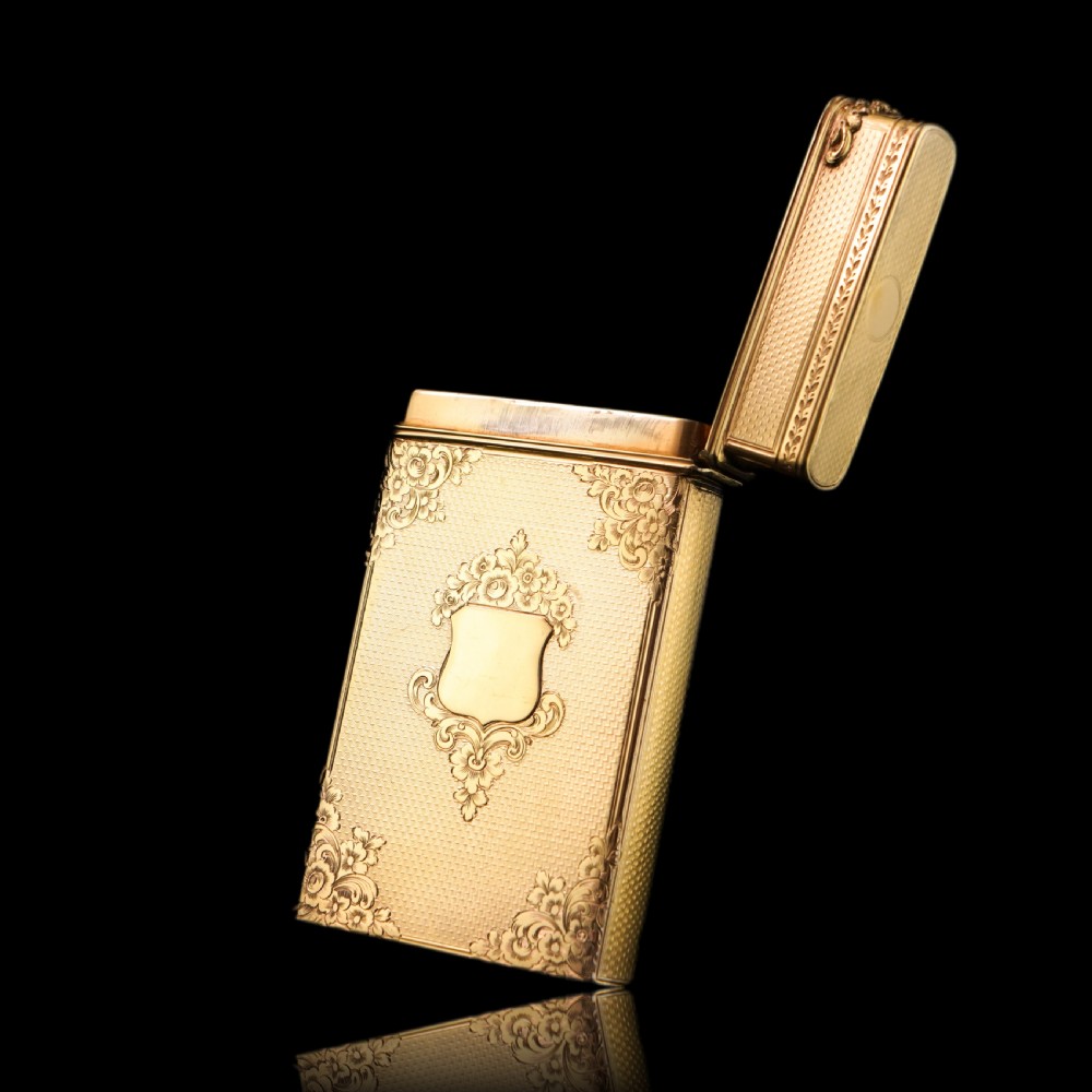 An antique Victorian sterling silver gilt cigar case featuring fine engine-turned texturing, scroll engraving, and a central unengraved cartouche. View XVII