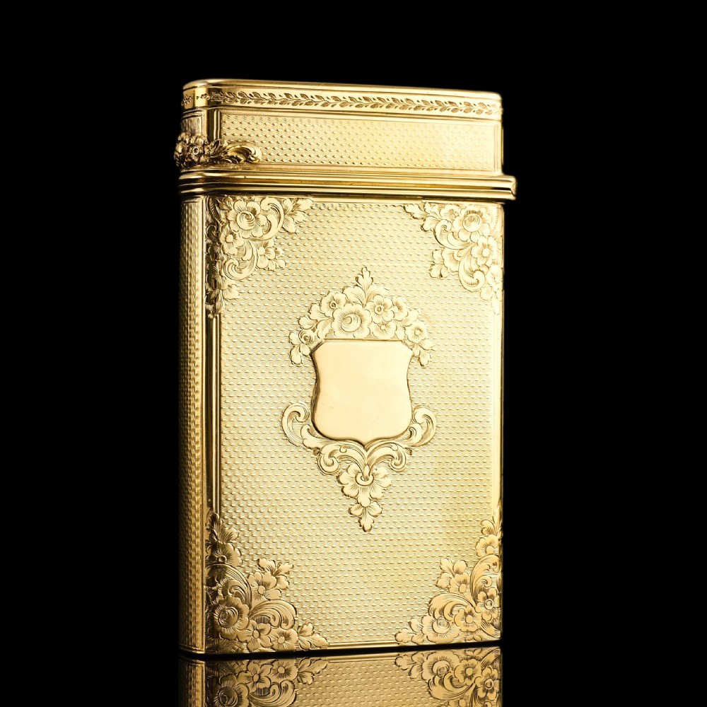 An antique Victorian sterling silver gilt cigar case featuring fine engine-turned texturing, scroll engraving, and a central unengraved cartouche. View XXI