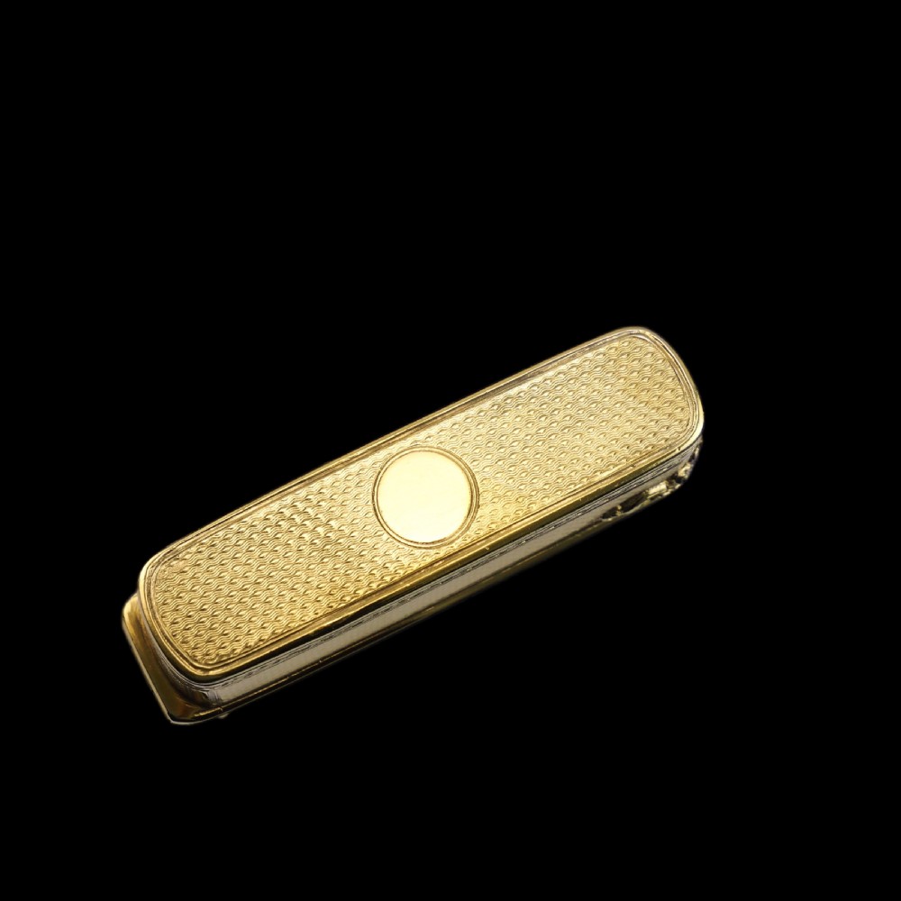 An antique Victorian sterling silver gilt cigar case featuring fine engine-turned texturing, scroll engraving, and a central unengraved cartouche. View XXII