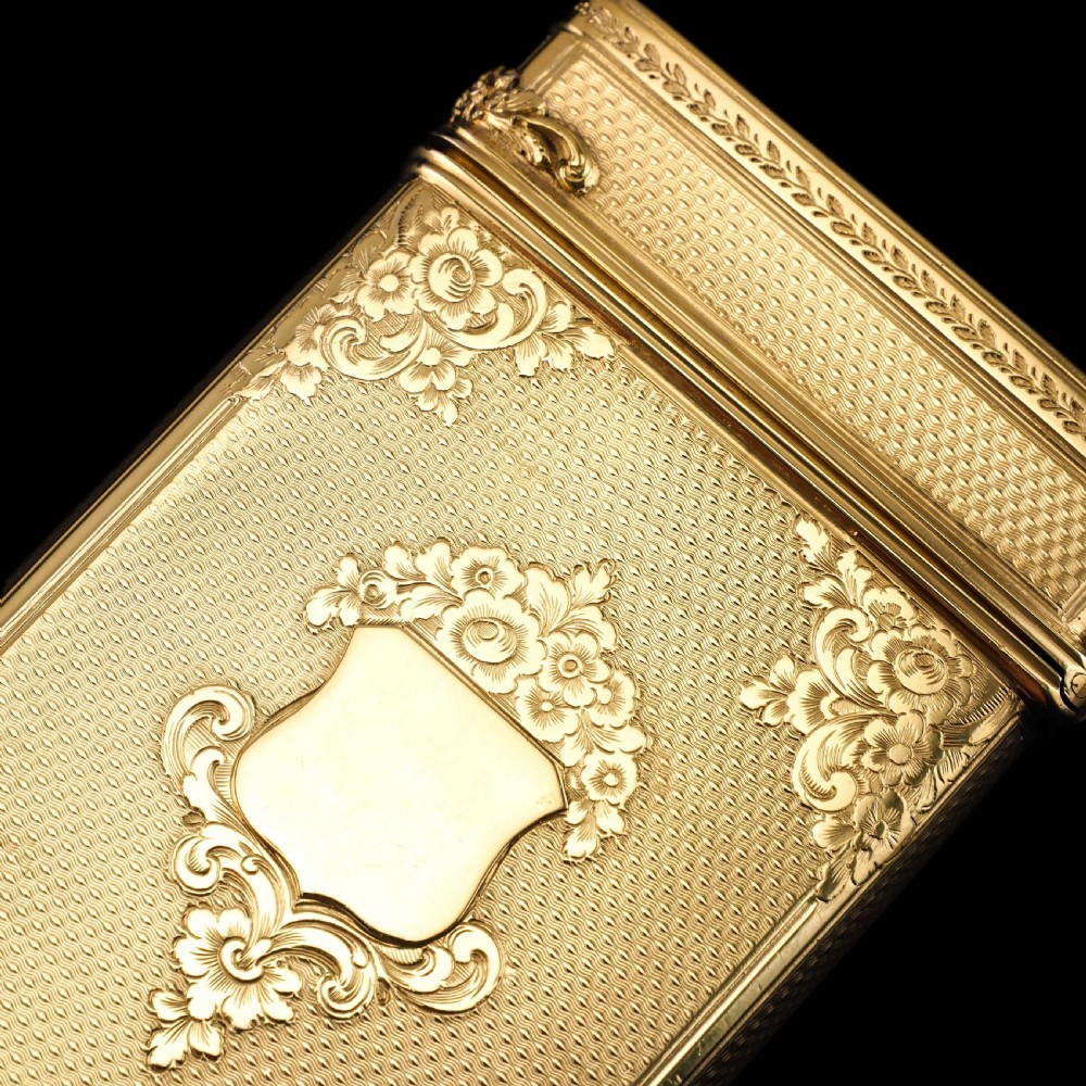 An antique Victorian sterling silver gilt cigar case featuring fine engine-turned texturing, scroll engraving, and a central unengraved cartouche. View XXVI