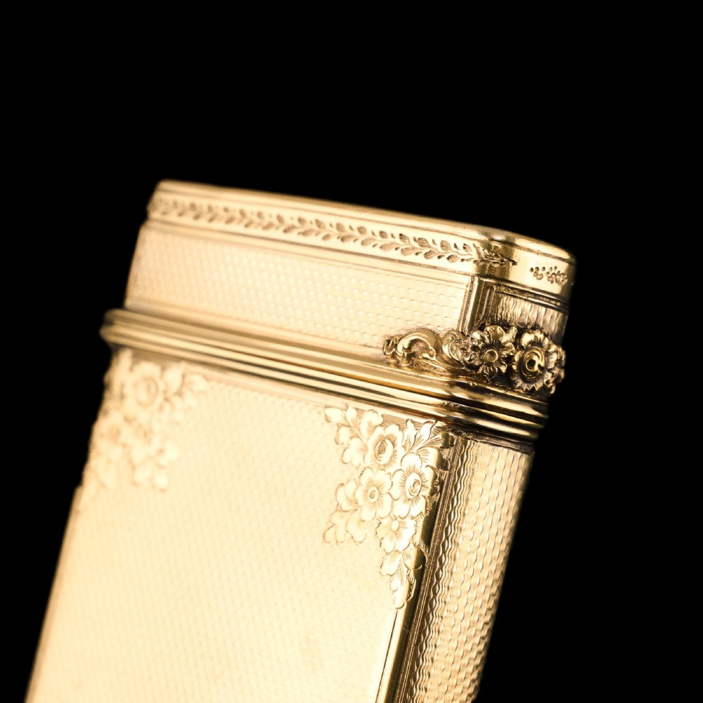 An antique Victorian sterling silver gilt cigar case featuring fine engine-turned texturing, scroll engraving, and a central unengraved cartouche. View XXVII