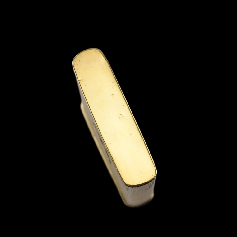 An antique Victorian sterling silver gilt cigar case featuring fine engine-turned texturing, scroll engraving, and a central unengraved cartouche. View XXVIII