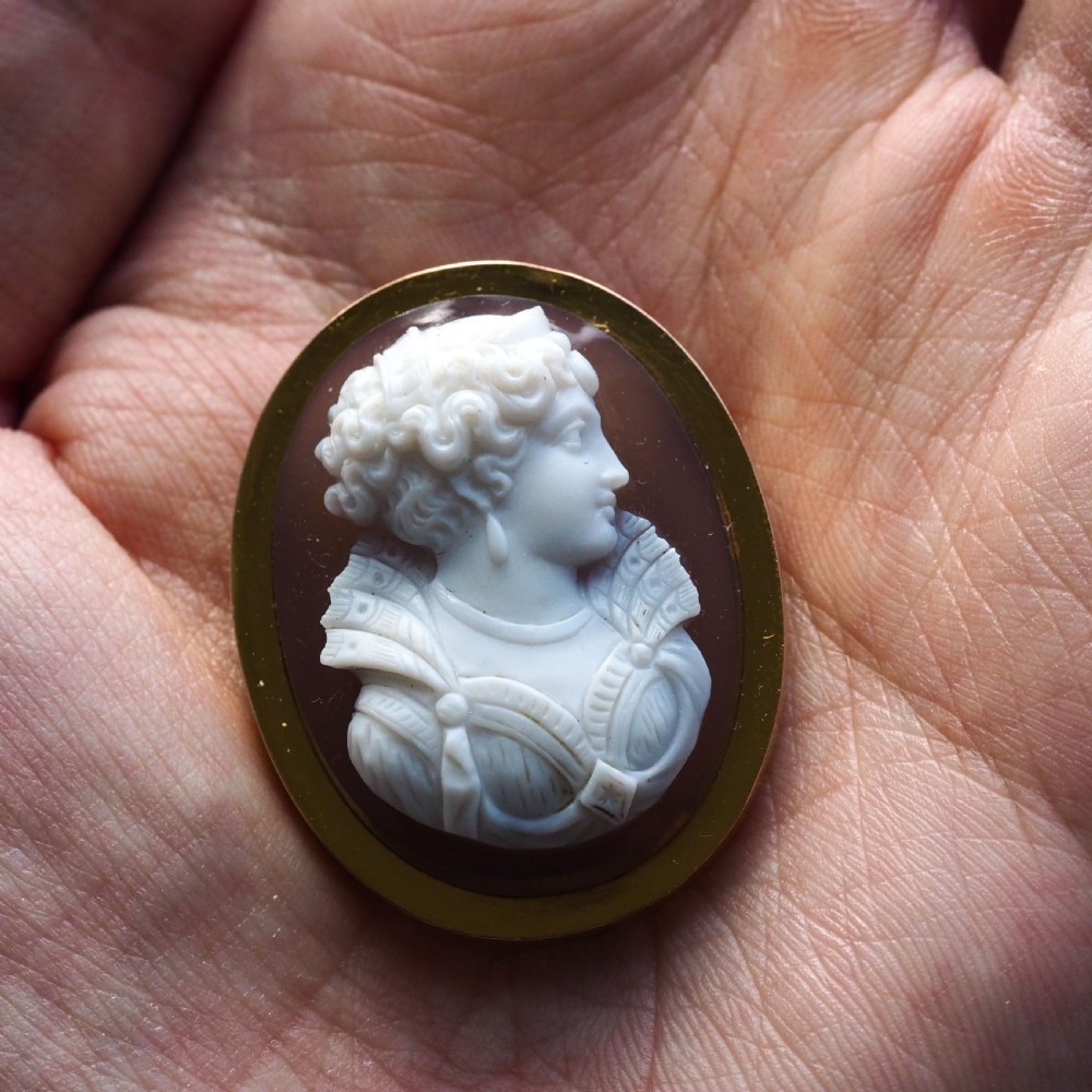 An oval Victorian brooch featuring a white hand-carved agate female portrait profile set within a smooth 18ct yellow gold frame. View II