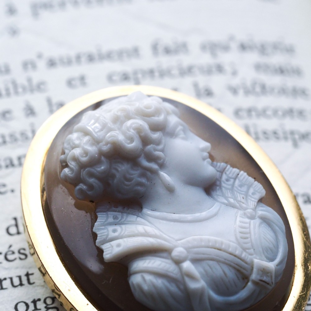 An oval Victorian brooch featuring a white hand-carved agate female portrait profile set within a smooth 18ct yellow gold frame. View IV