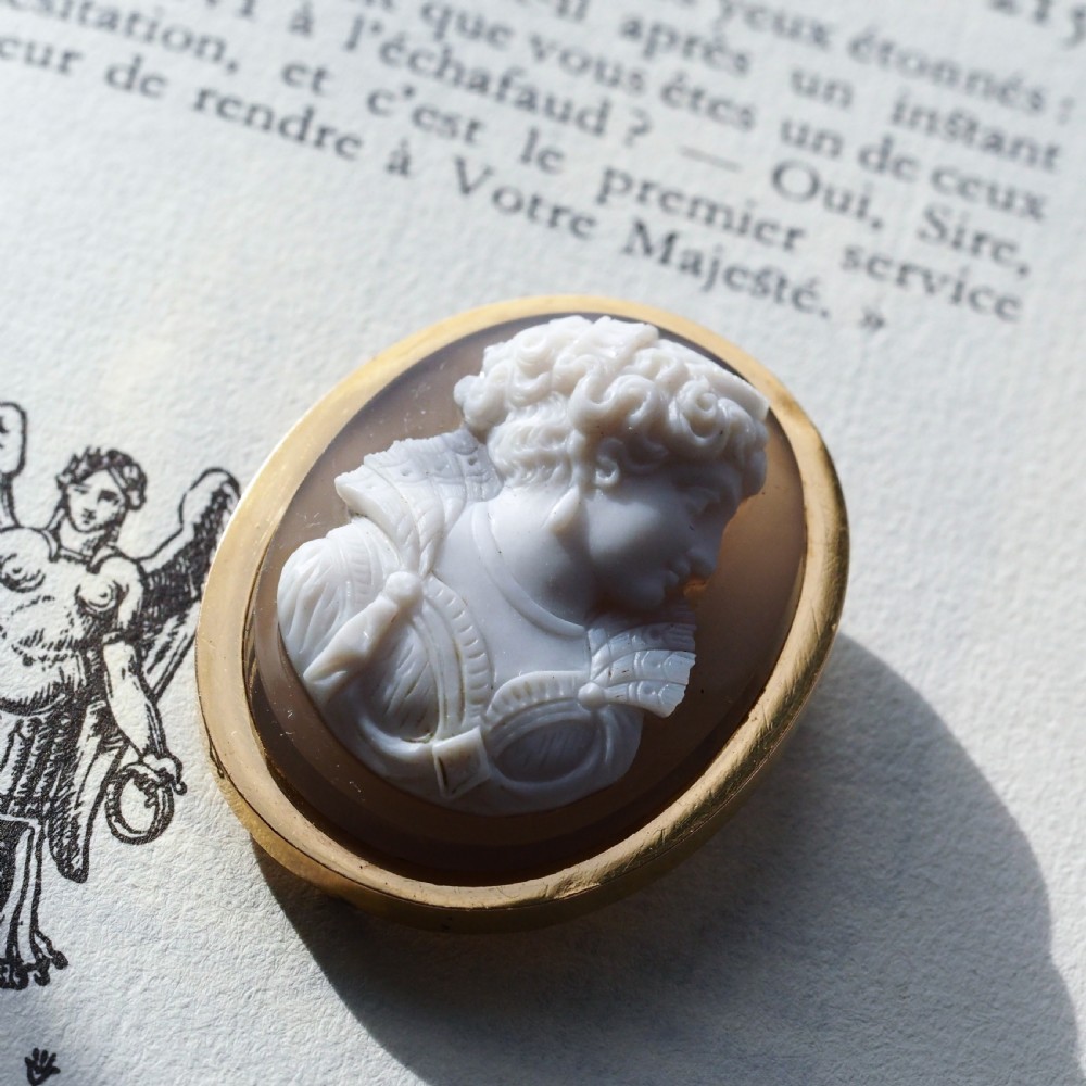 An oval Victorian brooch featuring a white hand-carved agate female portrait profile set within a smooth 18ct yellow gold frame. View V