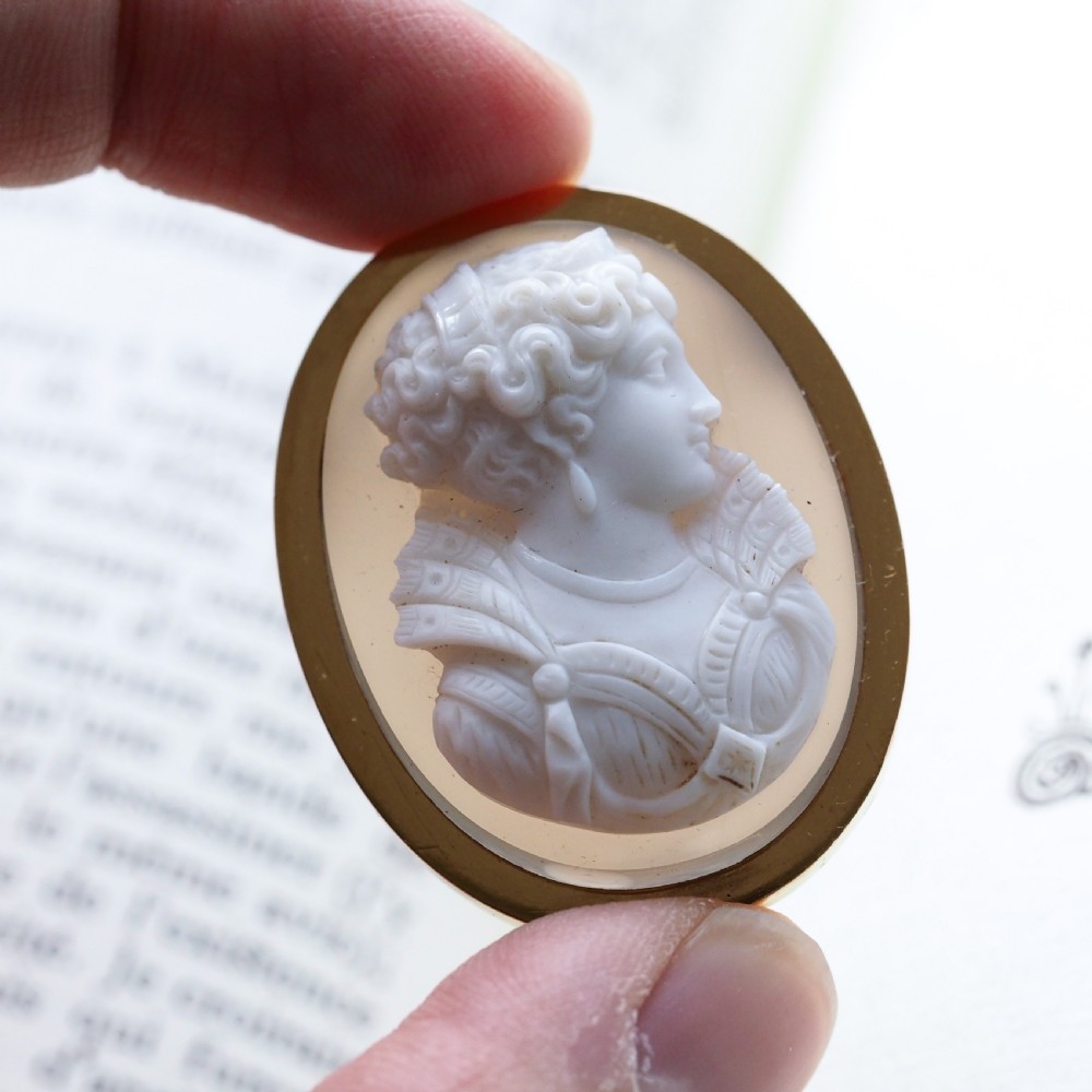 An oval Victorian brooch featuring a white hand-carved agate female portrait profile set within a smooth 18ct yellow gold frame. View VI