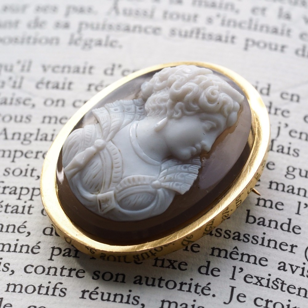 An oval Victorian brooch featuring a white hand-carved agate female portrait profile set within a smooth 18ct yellow gold frame. View VII