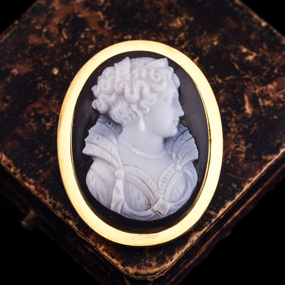 An oval Victorian brooch featuring a white hand-carved agate female portrait profile set within a smooth 18ct yellow gold frame. View X