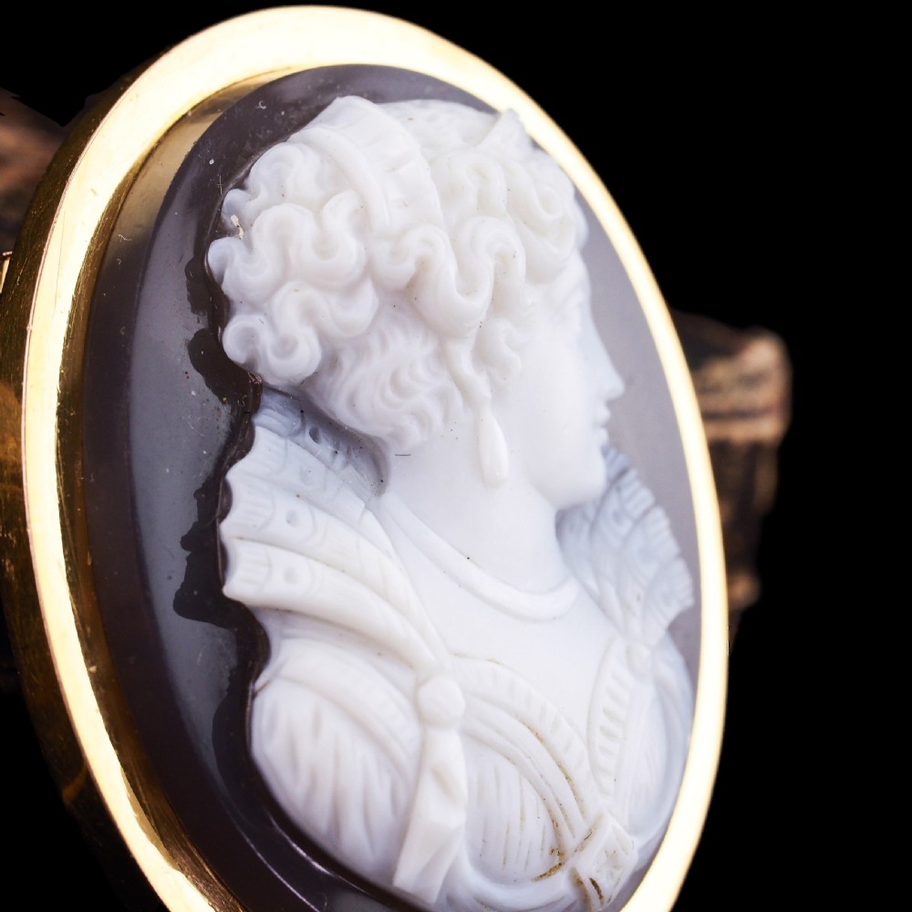 An oval Victorian brooch featuring a white hand-carved agate female portrait profile set within a smooth 18ct yellow gold frame. View XII