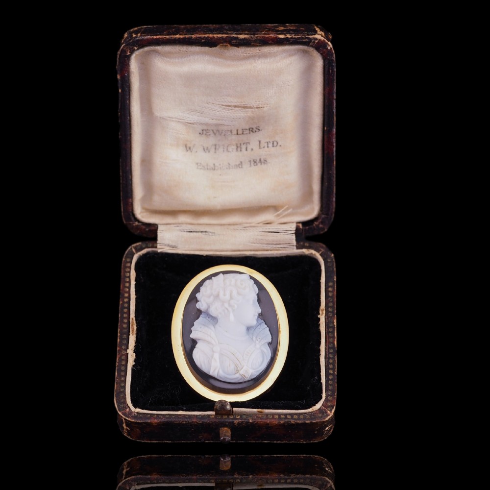 An oval Victorian brooch featuring a white hand-carved agate female portrait profile set within a smooth 18ct yellow gold frame. View XVI